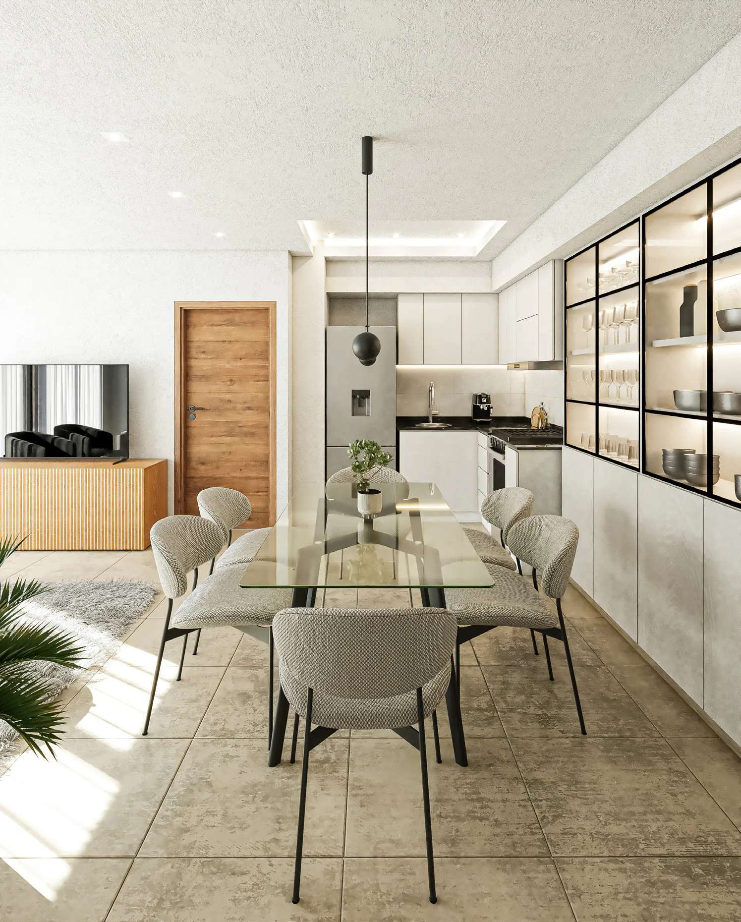 Comedor con una mesa de vidrio y sillas tapizadas grises junto a una cocina blanca, con un mueble vidriado iluminado y una puerta de madera al fondo