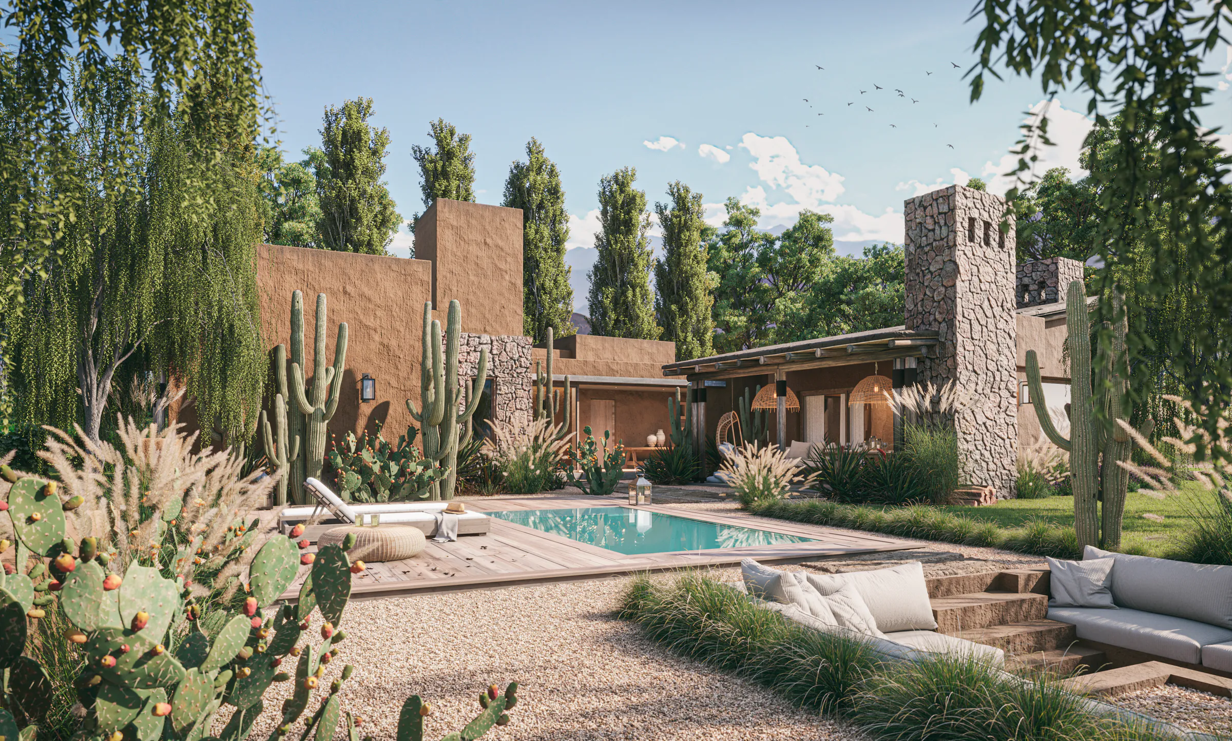 Patio de una casa de tierra y piedra con pileta rectangular y deck de madera, sillones hundidos en primer plano, cardones, tunas con fruto y una torre de piedra