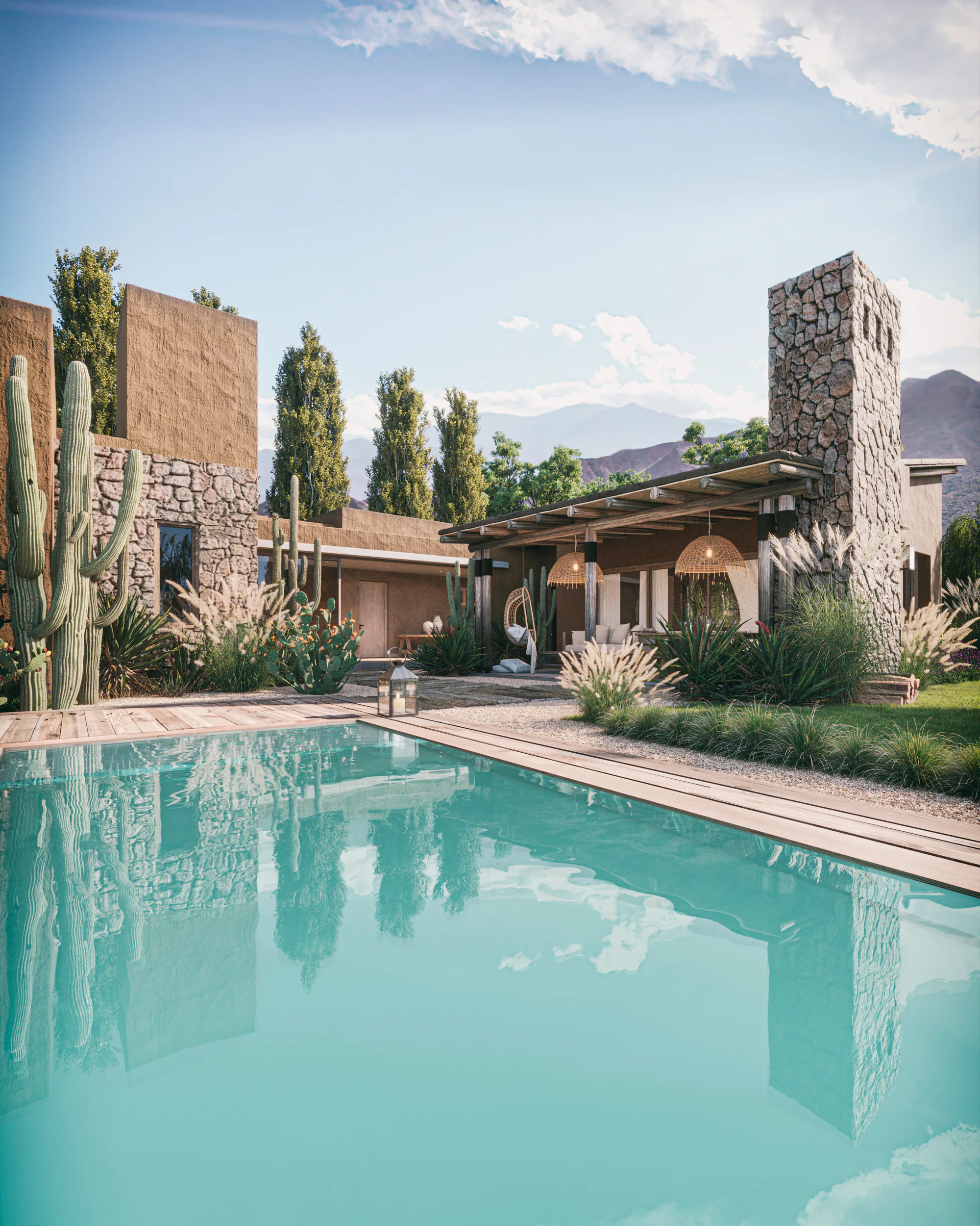 Casas bajas de tierra y piedra con pileta, entre álamos, sauces y cardones, con cerros al fondo