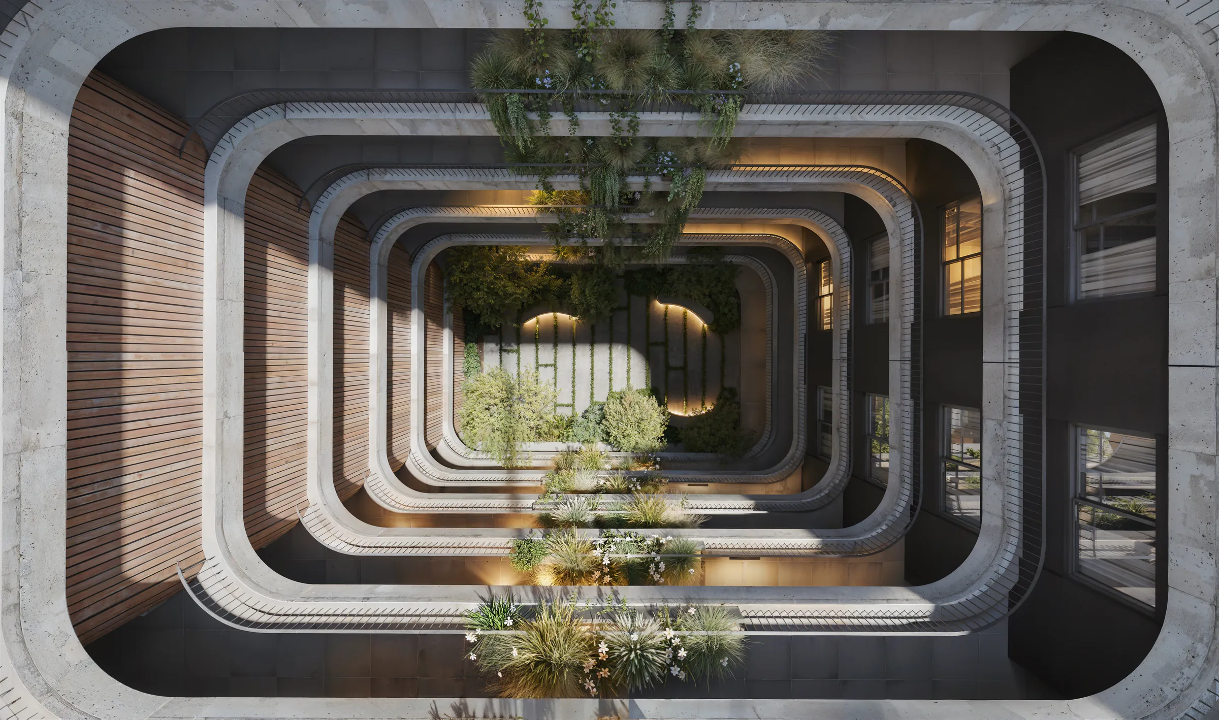 Vista cenital del patio interior: los bordes redondeados de hormigón de cada piso forman anillos que bajan hasta el jardín de planta baja, con barandas finas, jardineras colgantes y un muro de madera a la izquierda