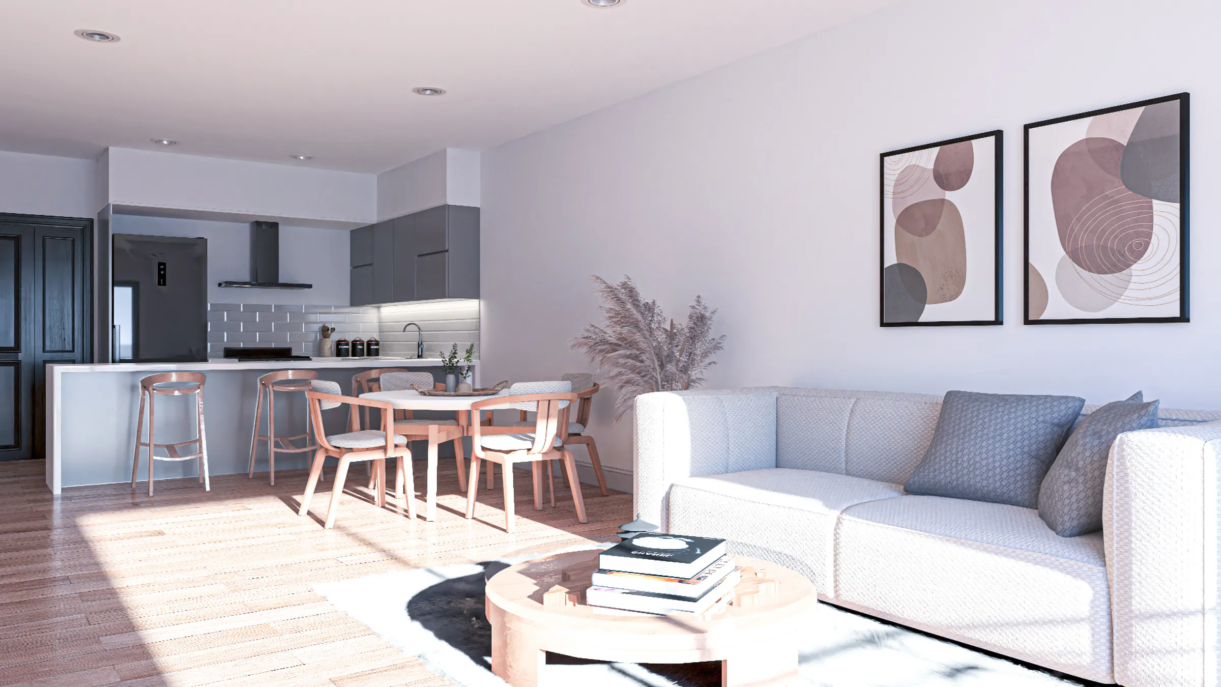 Living con sillón blanco y mesa ratona, comedor con mesa redonda y cocina con barra al fondo, con piso de madera y cuadros en la pared
