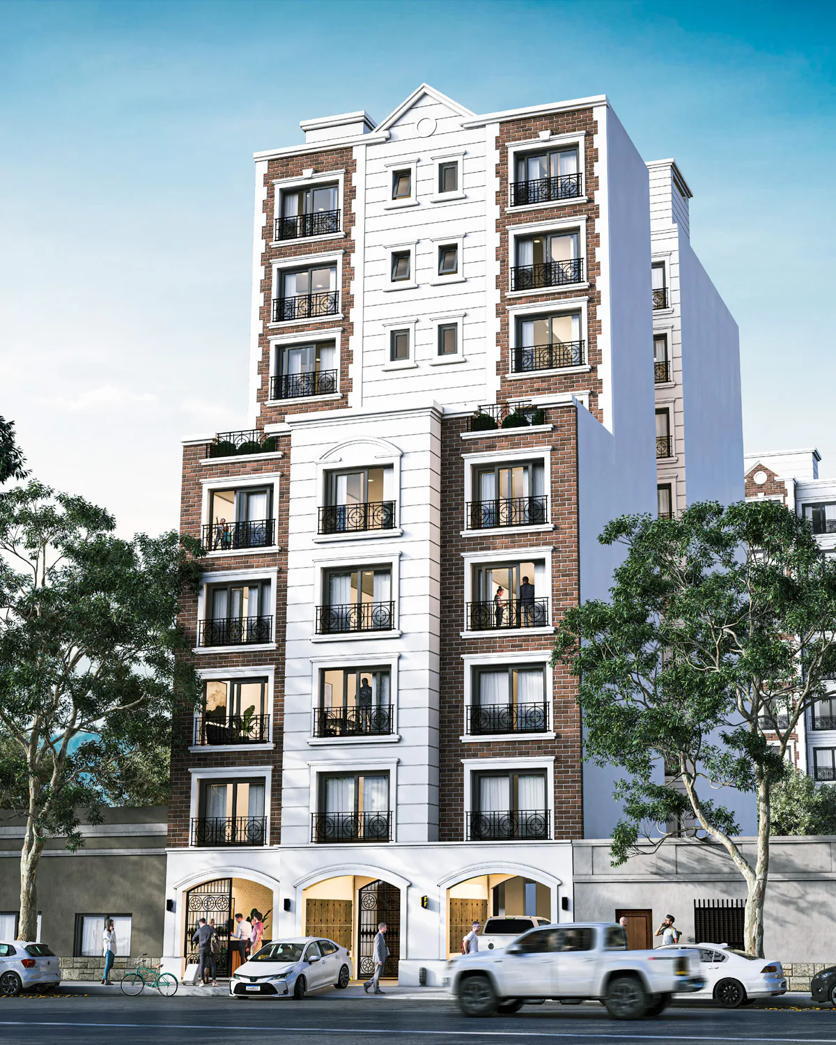 Torres Cardine desde la calle: edificio de fachada de ladrillo visto con paños blancos y molduras, balcones franceses de hierro negro y tres arcos de acceso en planta baja; detrás asoma otra de las torres, entre árboles altos, autos estacionados y peatones en la vereda