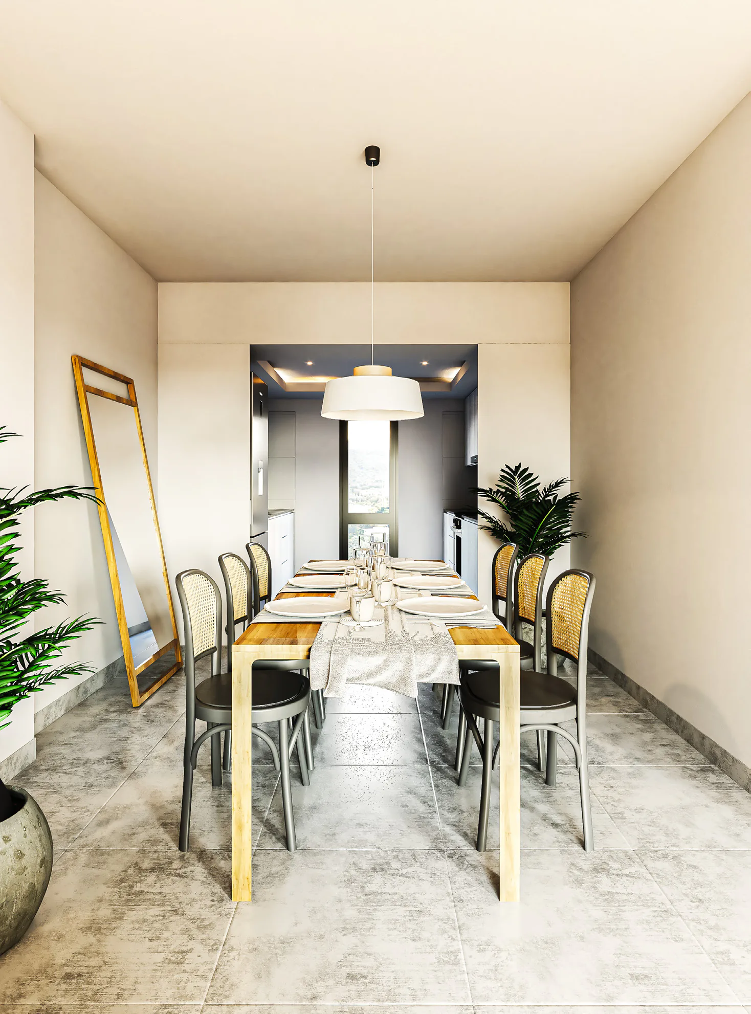 Comedor con una mesa de madera y sillas de esterilla, una lámpara colgante blanca, un espejo de pie y, al fondo, la cocina